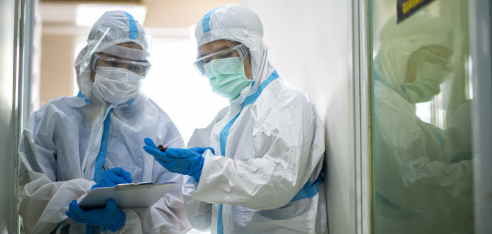 Asian doctor checking coronavirus or covid-19 infected patient in quarantine room