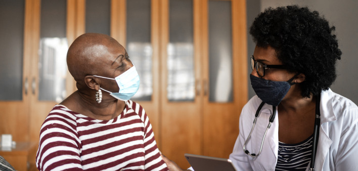 Health visitor and a senior woman during nursing home visit