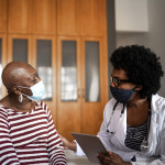 Health visitor and a senior woman during nursing home visit