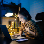 Asian woman was sick with chest pain working on a laptop overtime at home. WFH. Work from home for avoid the Coronavirus COVID 19