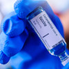 Image of Hand holds Coronavirus Covid-19 Vaccine glass bottle.