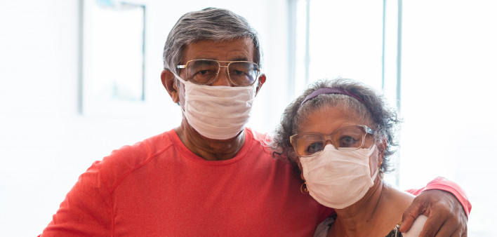 Senior couple wearing protective mask against infectious diseases