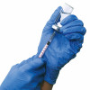 hands with blue gloved filling a syringe from a vial of vaccine
