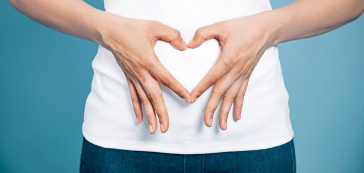 woman making shape of heart with her hands