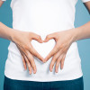 woman making shape of heart with her hands