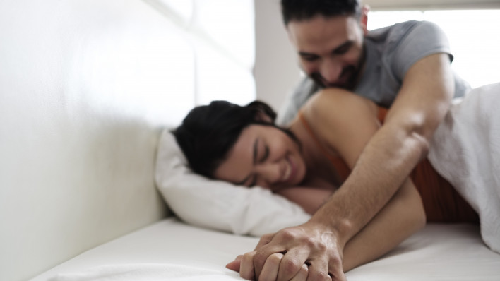 Latino couple in bed