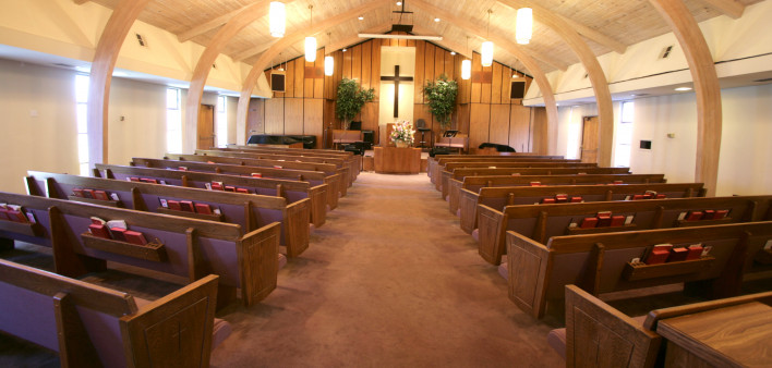 Sanctuary of a small church with pews and pulpit