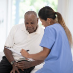 An Elderly Gentleman in His Doctors Office Receiving a Check-Up