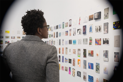 Viewers take in the 1,662 postcards on display.