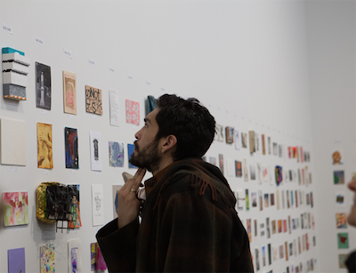 Viewers take in the 1,662 postcards on display.