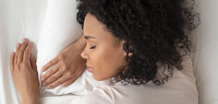young woman sleeping in bed