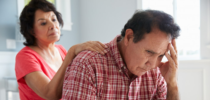 Wife Comforting Senior Husband Suffering With Dementia