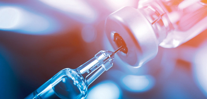 needle going into a vial vaccine medication