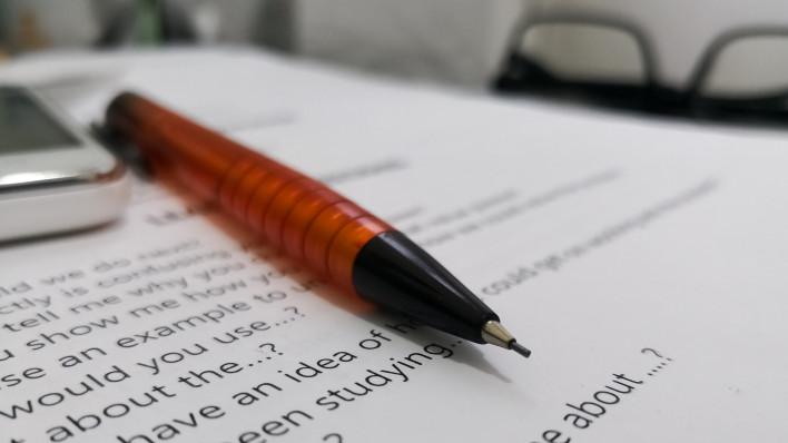 close up of agreement with pen