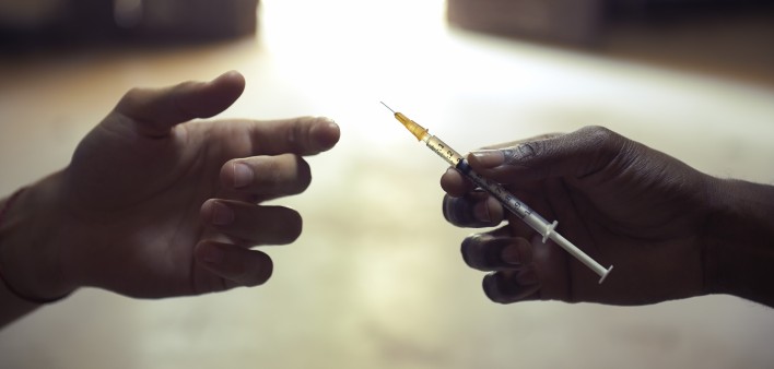drug users passing a syringe