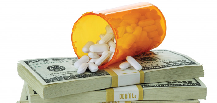 cost of healthcare bottle of pills on money