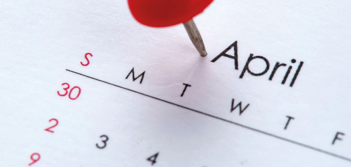 Calendar month of April with red push pin