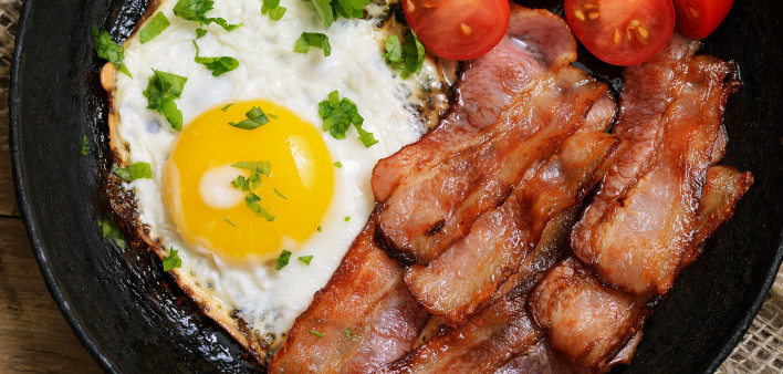 Appetizer fried egg with bacon in frying pan