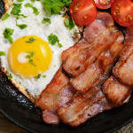 Appetizer fried egg with bacon in frying pan