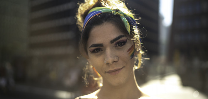 Transgender woman looking at camera during pride parade
