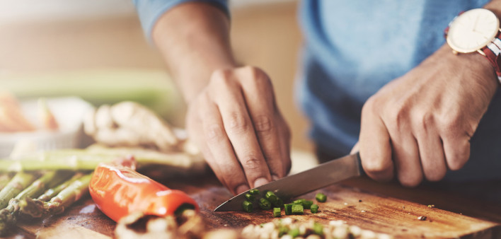 Cropped shot of a man preparing a healthy meal at home