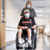 Mark Buchanan of Roopville, Georgia, is wheeled down a hallway by his wife, Melissa, at the University of Florida Health Shands Hospital in January.