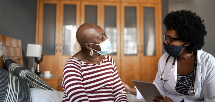 Health visitor and a senior woman during nursing home visit