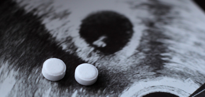 Ultrasound of a pregnant woman and pills medication