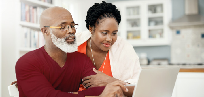 Shot of a happy mature couple using a laptop together at home