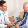 American doctor talking to senior man in surgery