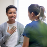 young woman taking to her doctor