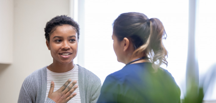 young woman taking to her doctor