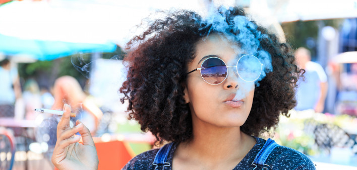 African American woman smoking in cafeteria