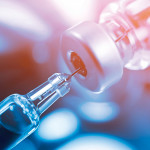 needle going into a vial vaccine medication