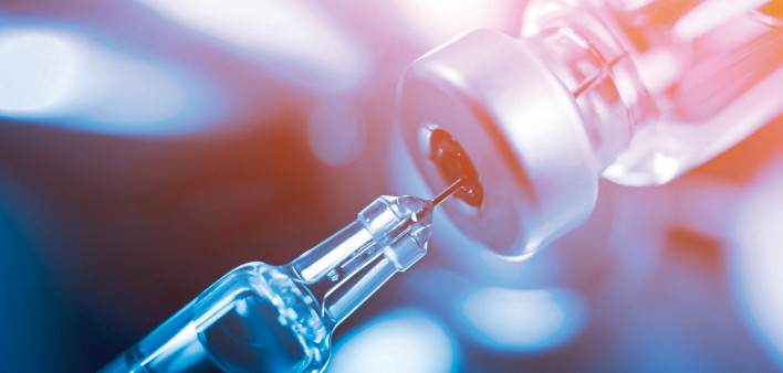 needle going into a vial vaccine medication