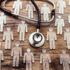 photo illustration figures and stethoscope on wood