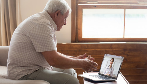 Elderly man make distant video call communicating with doctor online s