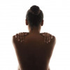 womans back with her hands on her shoulders