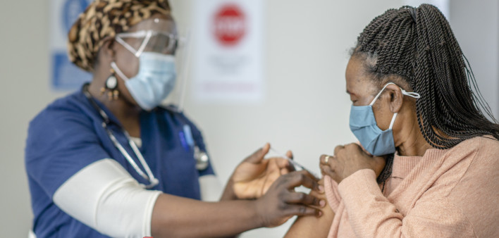 A senior female is receiving her COVID-19 vaccine
