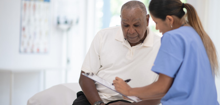 An Elderly Gentleman in His Doctors Office Receiving a Check-Up
