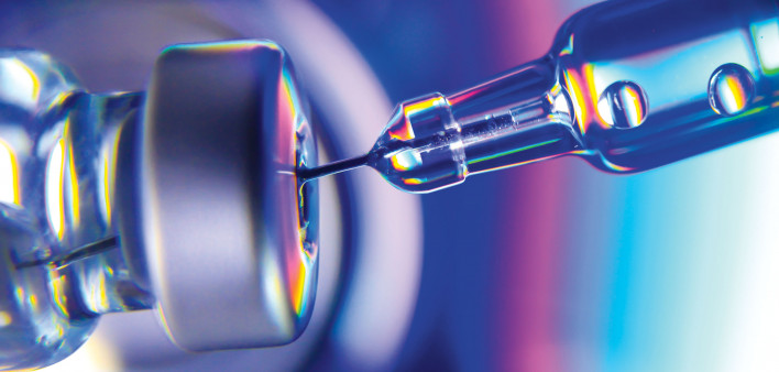 needle going into vial vaccine