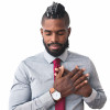 black man holding hands to heart eyes closed smiling