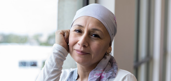 A peaceful photo of a breast cancer patient wearing a scarf to cover her head.