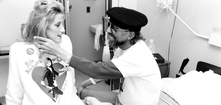 Ward 5B caregiver Rita Rockett visits with a patient.