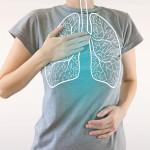 woman holding chest diagram of lungs