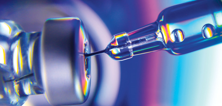 needle going into vial vaccine