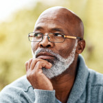 senior man outdoors thinking