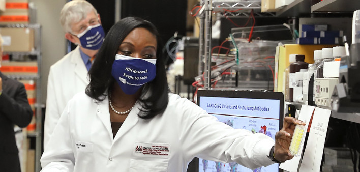 President Joe Biden speaks with Kizzmekia Corbett, PhD, the lead COVID-19 vaccine scientist, during his visit to the U.S. National Institutes of Health.