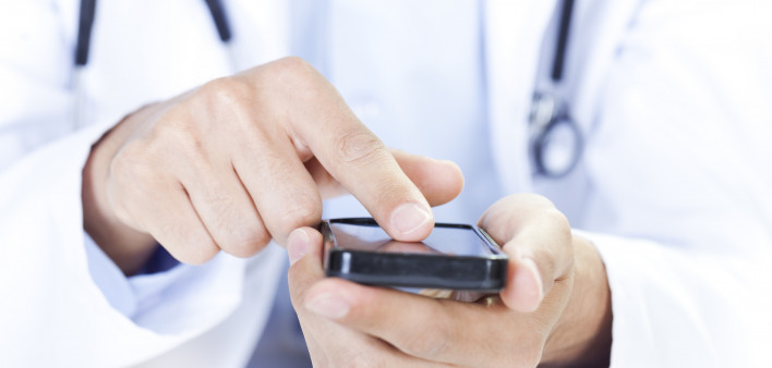  a doctor touching a smart phone