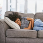 girl sick sleeping on couch